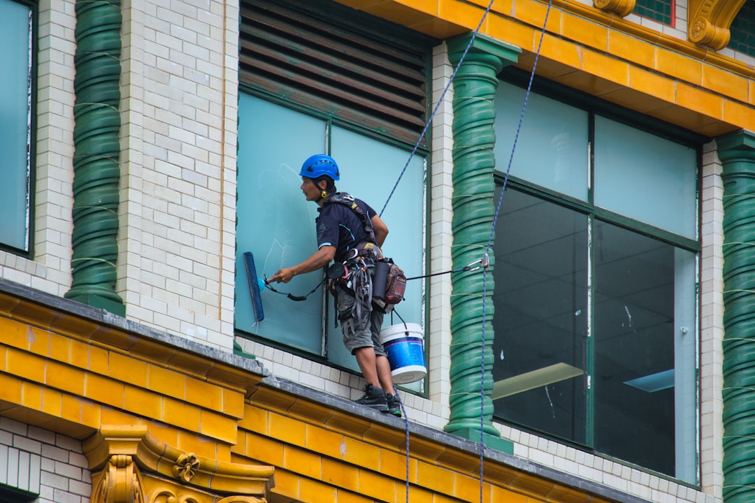 A window cleaner cleaning the windows of a building.
